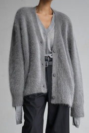 Dark gray angora button cardigan with sculpted sleeves over a v-neck top.
