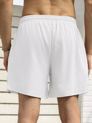 Men's white drawstring chino shorts with pockets, shown from the back.