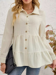 Cream textured tiered button-down shirt with crinkled fabric and button details.