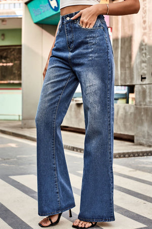 Flared denim jeans in medium blue with subtle distressing and a button closure.