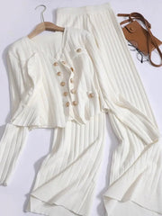 White ribbed knit ensemble with gold buttons, featuring a cardigan and wide-leg pants.