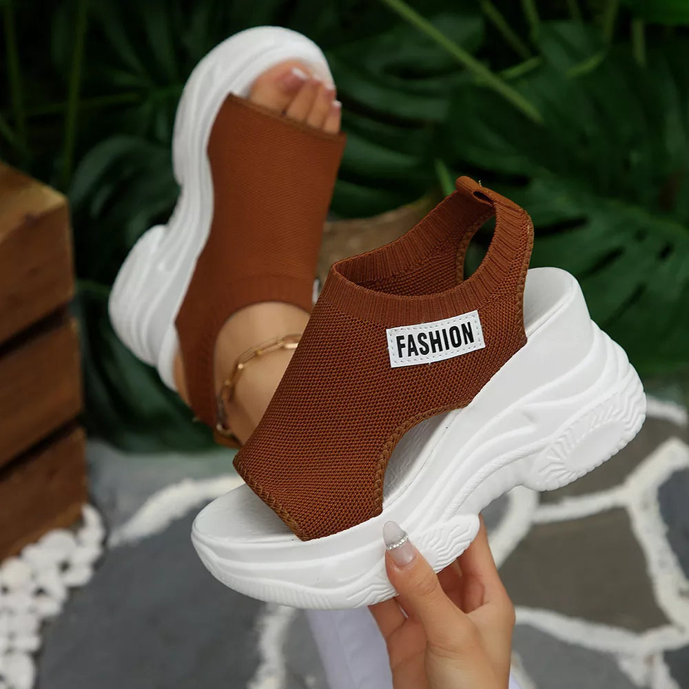 Brown open-toe wedge sandals with white chunky sole and "FASHION" label.