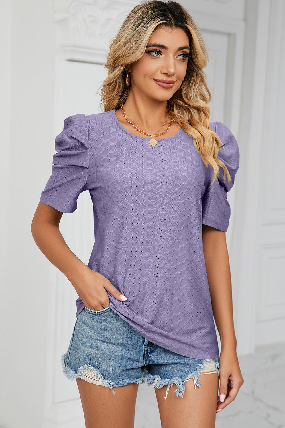 Lavender perforated puff sleeve top with textured pattern and crew neck.