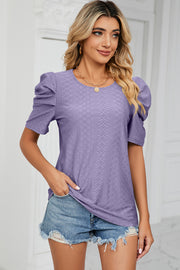 Lavender perforated puff sleeve top with textured pattern and crew neck.