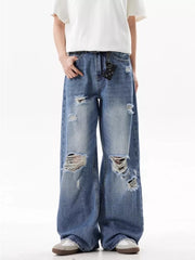 Men's distressed wide-leg jeans in blue denim with ripped details and a relaxed fit.