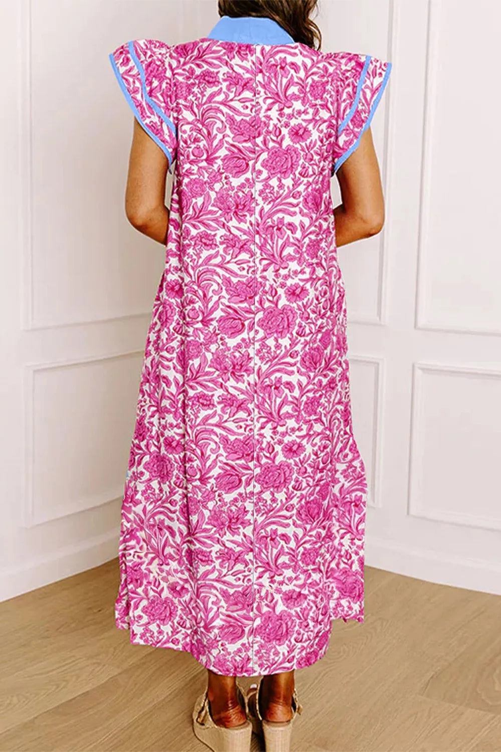 Midi dress with vibrant pink floral print, ruffle sleeves, and blue trim.