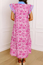Midi dress with vibrant pink floral print, ruffle sleeves, and blue trim.