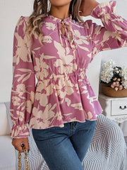 Floral peplum blouse with ruffled neck and tie detail in pink purple, long sleeves, cinched waist
