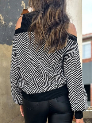Black chevron knit sweater with cutout shoulders and ribbed trim.