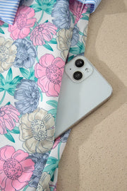 Floral mini dress with contrast trim and a button front, shown with a phone in the pocket.