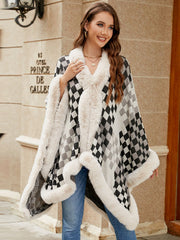 Checkered acrylic cape with plush faux fur trim and open front, styled with jeans.