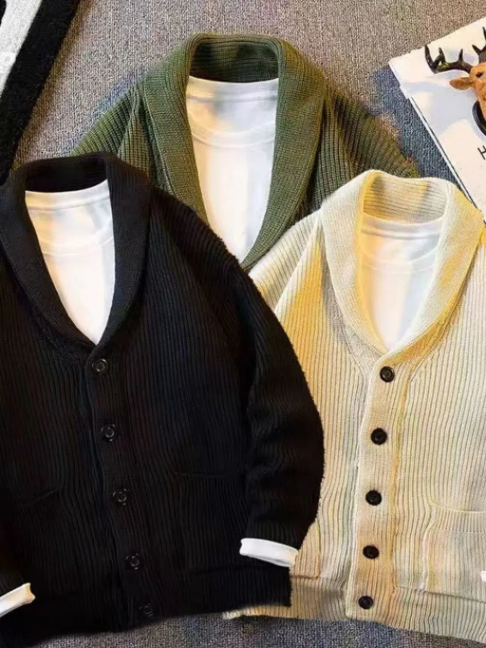Buttoned knit cardigans in black, beige, and army green with shawl collars.