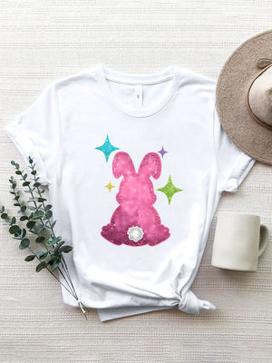 White t-shirt with a pink glitter bunny silhouette and colorful stars graphic.