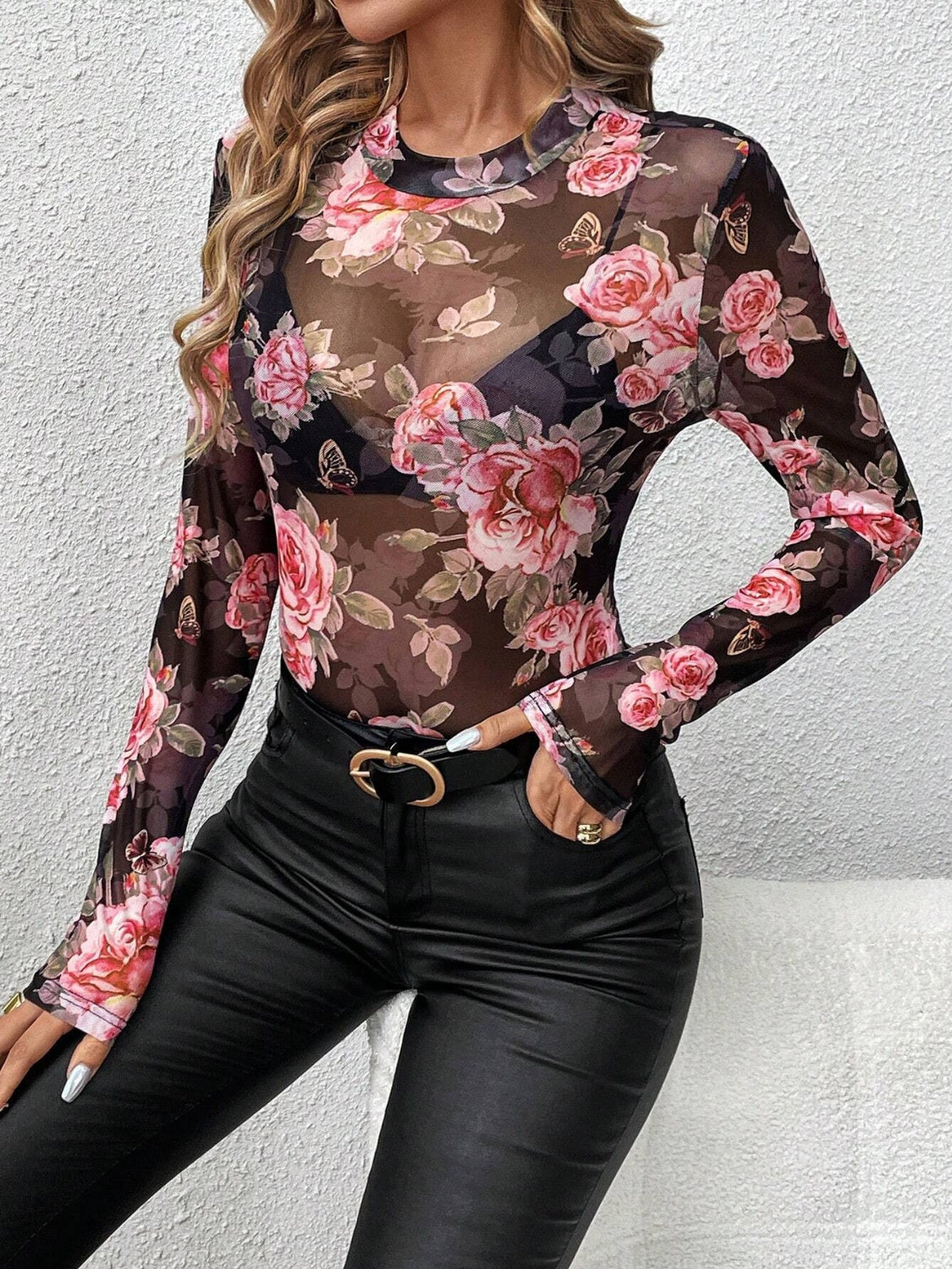 Black mesh bodysuit with long sleeves and a floral rose print, featuring a high neckline.