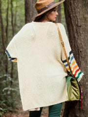 Cream knit duster cardigan with rainbow striped sleeves and open front, acrylic.