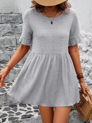 Light gray textured babydoll blouse with flutter sleeves and a gathered waist.