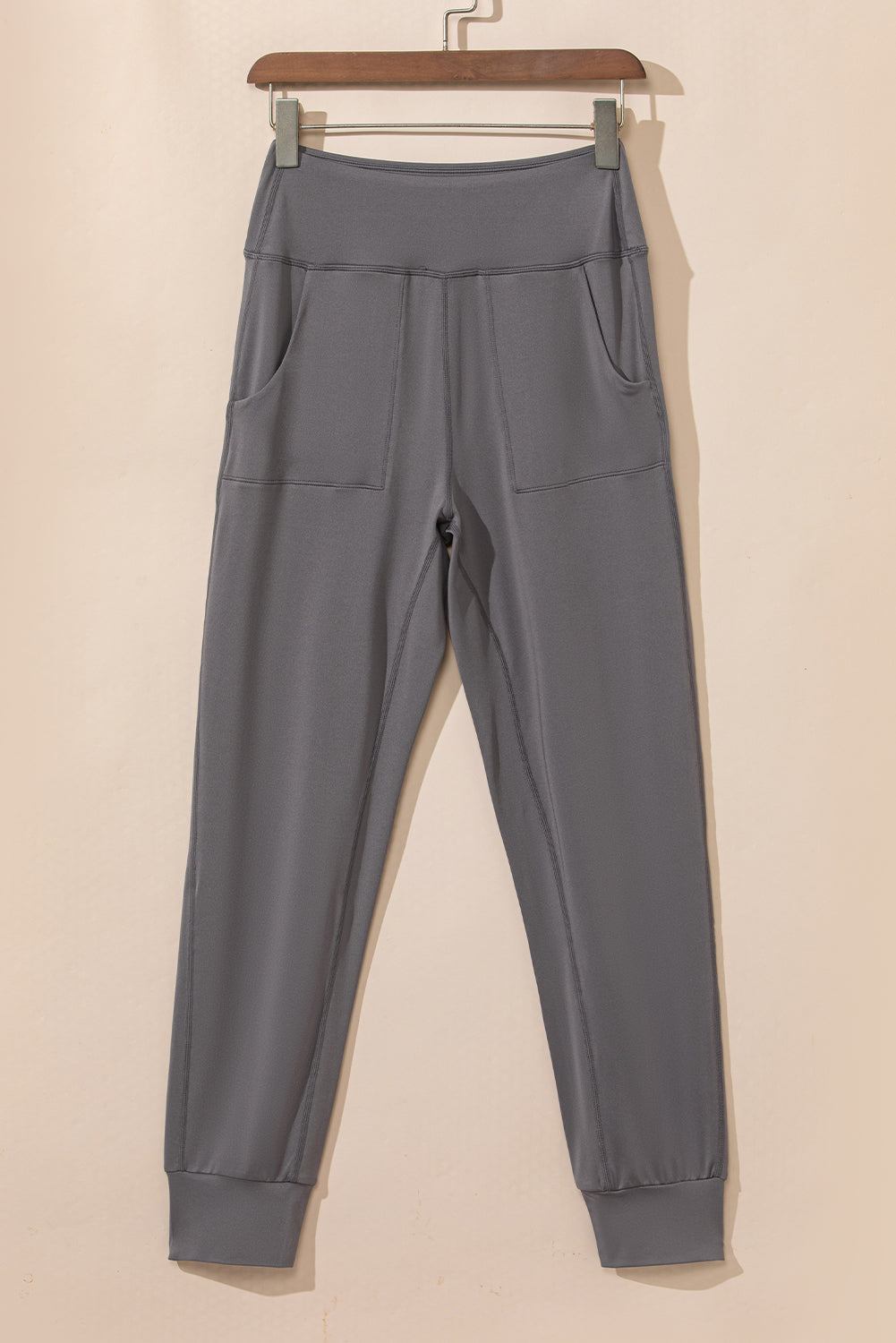 Dark gray joggers with performance fit, elastic waistband, and two front pockets.