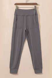 Dark gray joggers with performance fit, elastic waistband, and two front pockets.