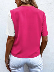 Two-tone hot pink and white short sleeve shirt with asymmetric color blocking.