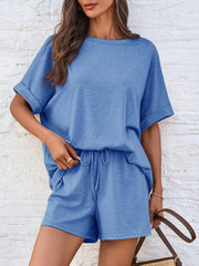 Blue relaxed fit tee and shorts set with drawstring waist and cuffed sleeves.