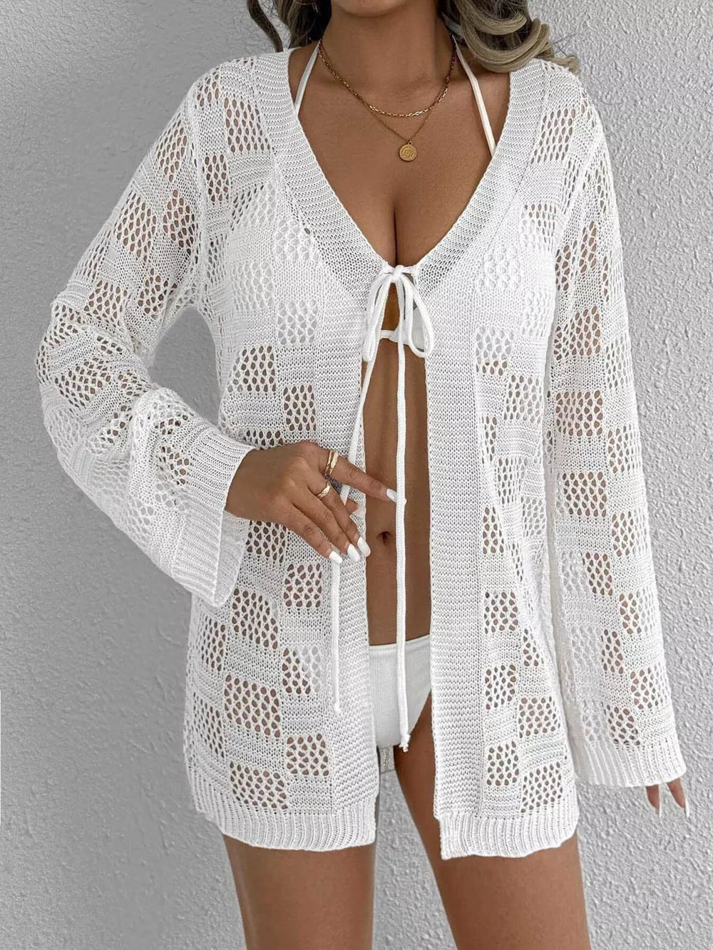 White openwork crochet tie-front cover-up with bell sleeves and a V-neck.