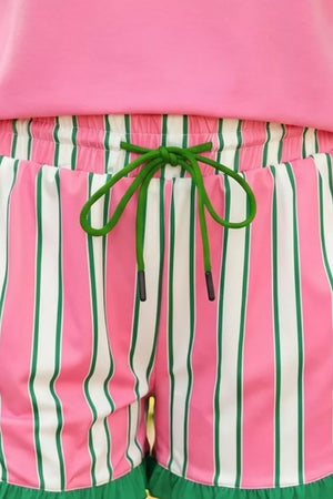 Pink and white striped chino shorts with green drawstring and frill hem.