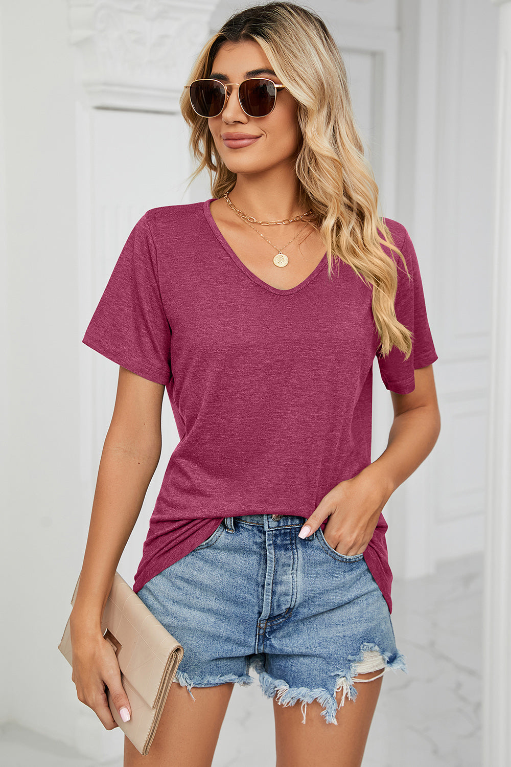Heathered v-neck t-shirt in magenta with short sleeves and a relaxed fit.