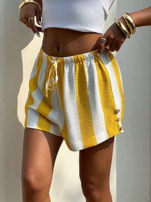Yellow and white striped drawstring shorts with button detail on hem.