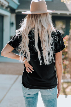 Black graphic tee with short sleeves and a casual fit, styled with jeans.