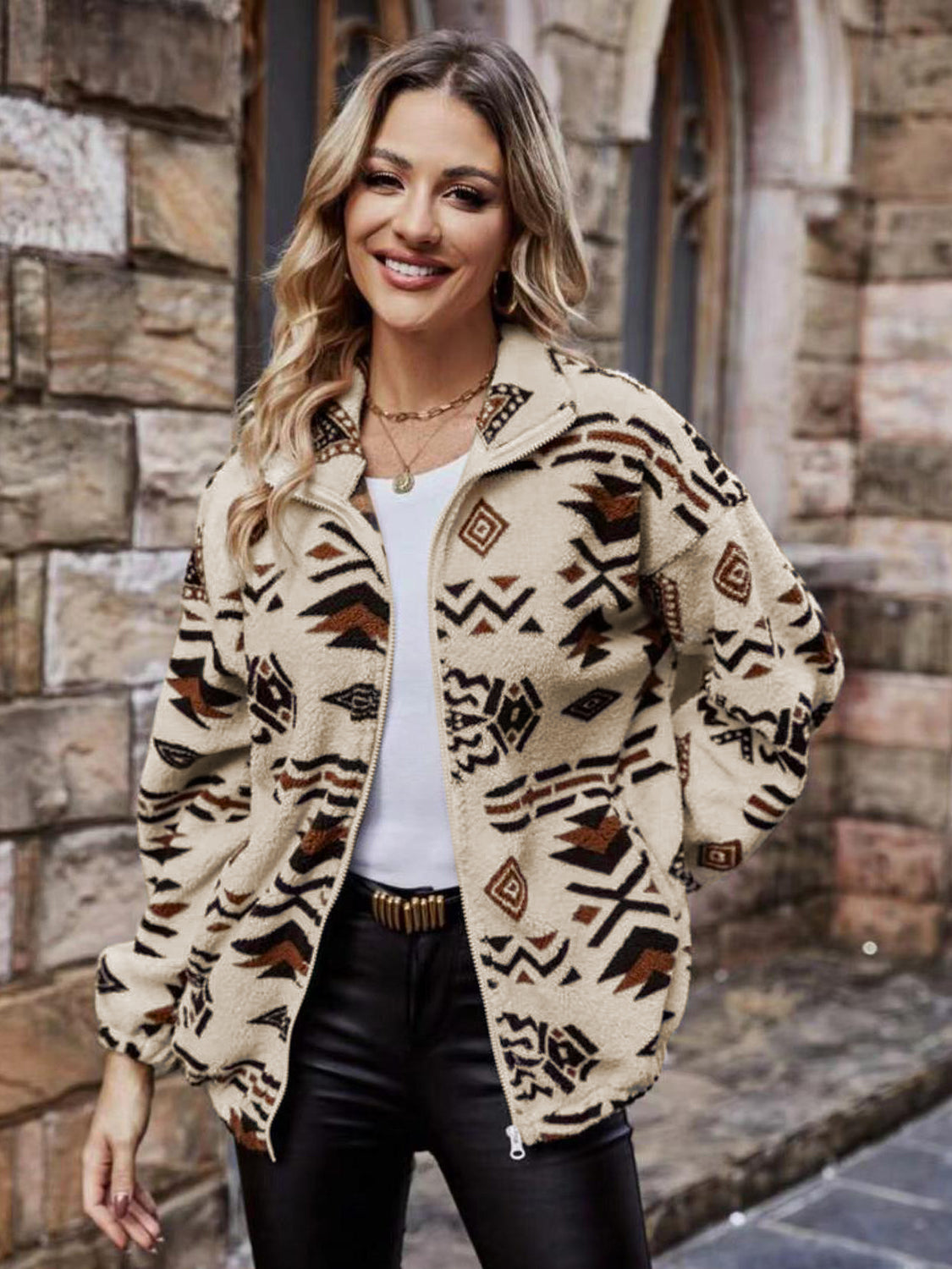 Aztec sherpa zip-up jacket in tan with a geometric pattern and stand-up collar.