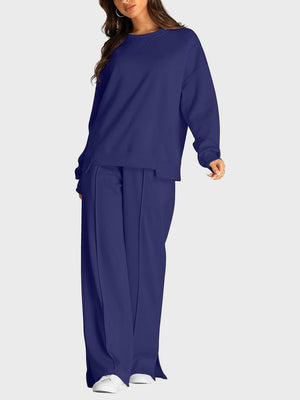 Dark blue seamed loungewear set with crew neck sweatshirt and slit-front wide-leg trousers.