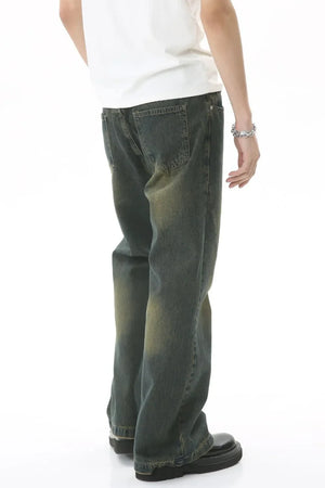Faded wash flare denim jeans in dark, with a relaxed fit and subtle whiskering.
