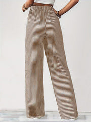Wide-leg drawstring trousers in black and white vertical stripes with an elastic waistband.