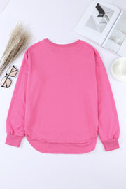 Rose Pink sweatshirt with asymmetric hemline and crew neck.