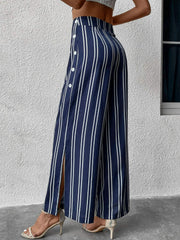 Dark blue vertical stripe palazzo trousers with side slit and button detail.