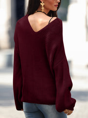 Burgundy knit sweater with V-neck and slouchy fit.
