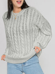 Cable knit openwork sweater in light grey acrylic with crew neck and long sleeves.