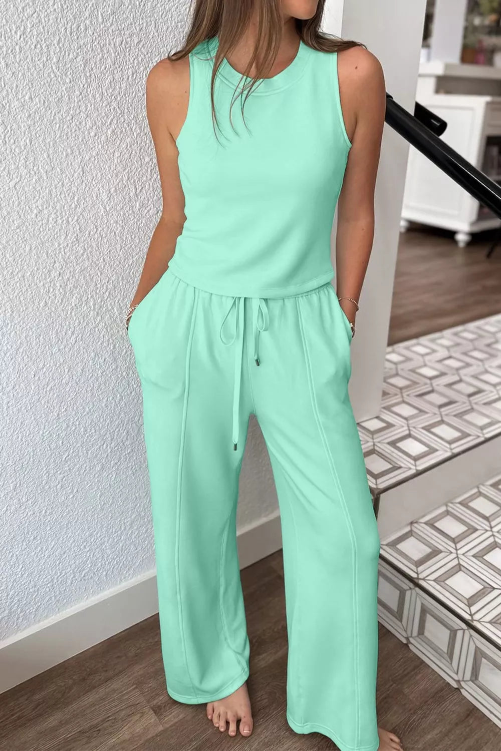 Mint green drawstring lounge set with sleeveless top and wide-leg pants with pockets.