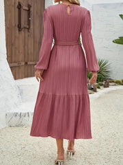 Pink pleated midi dress with tie waist and long sleeves, back view