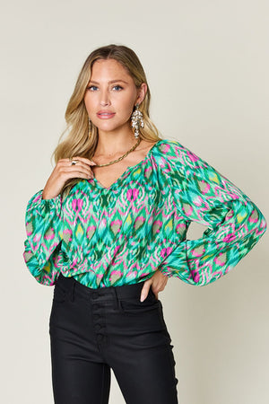 Green ikat print blouse with voluminous sleeves and v-neck
