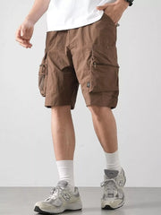 Brown cargo shorts with multiple zippered and flap pockets.