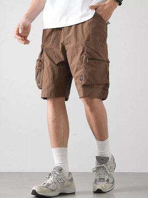 Brown cargo shorts with multiple zippered and flap pockets.