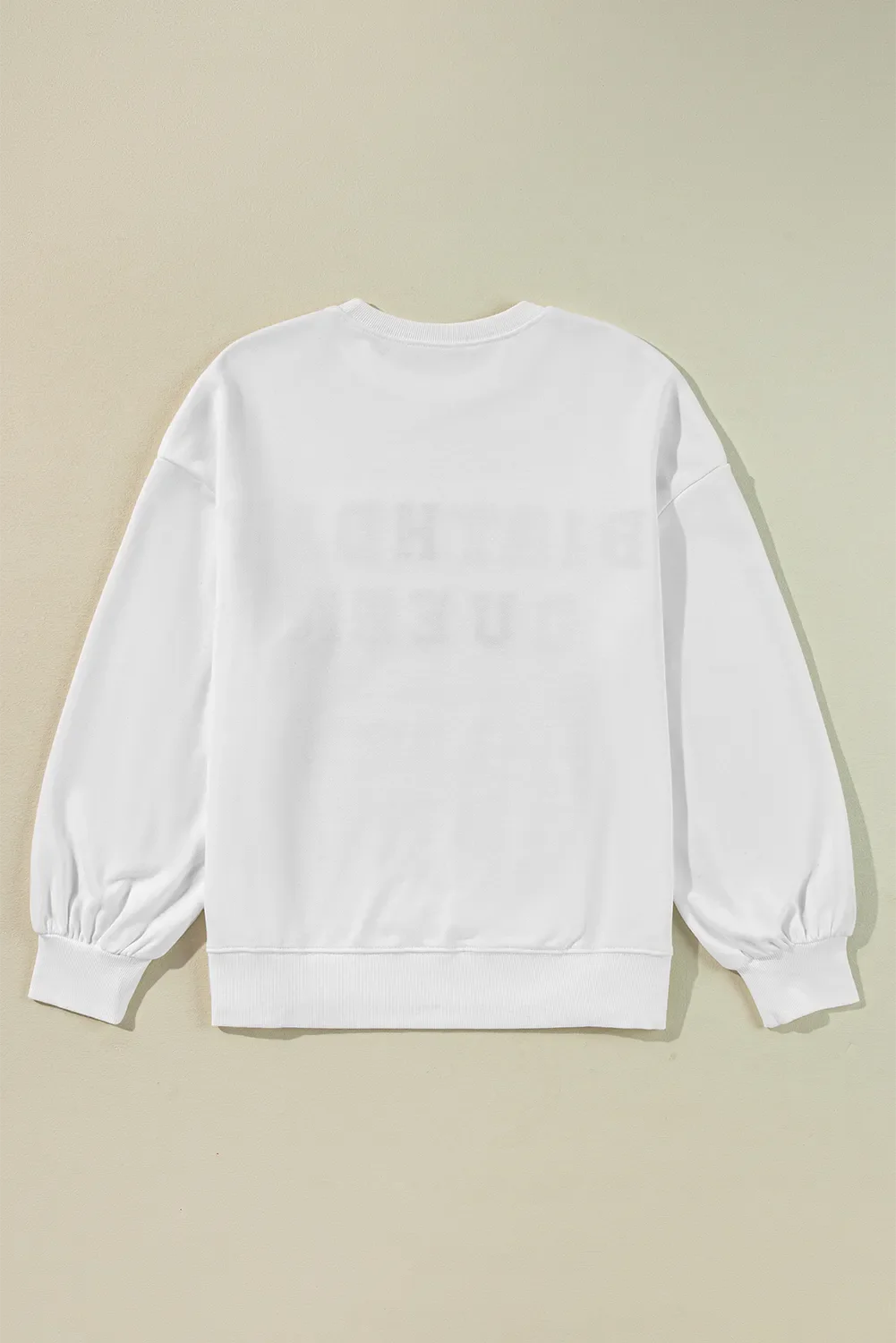 White sweatshirt with puff sleeves and "Birthday Queen" graphic