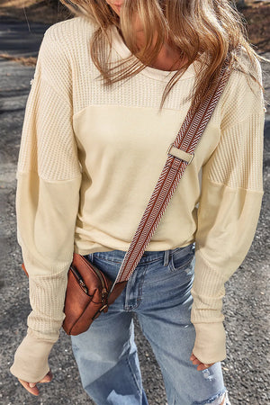 Beige waffle knit colorblock sweatshirt with crew neck and long sleeves.