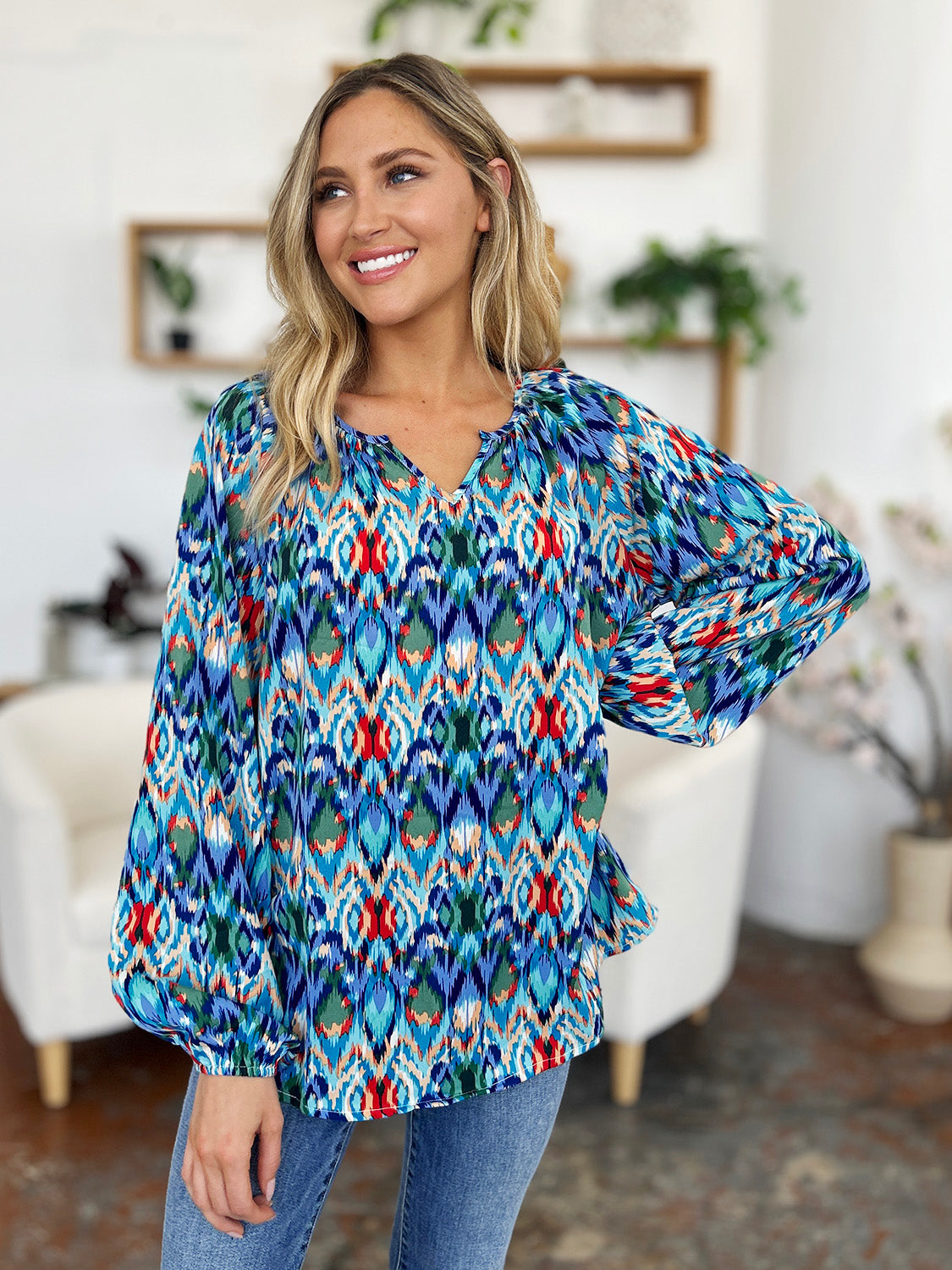 Prismatic ikat blouse with voluminous sleeves in blue and green, featuring a V-neck and relaxed fit.