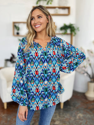 Prismatic ikat blouse with voluminous sleeves in blue and green, featuring a V-neck and relaxed fit.