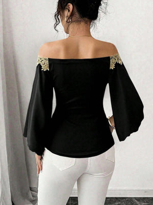 Black off-shoulder blouse with bell sleeves and gold lace trim.