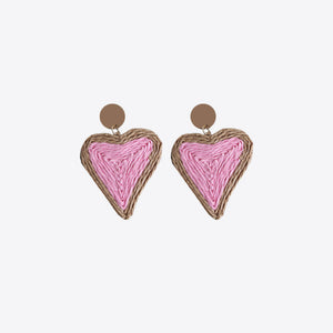 Pink woven heart statement earrings with natural raffia trim and brown stud backing.