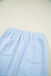 Light blue cable knit lounge pants with elastic waistband and two back pockets.