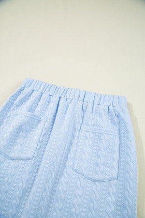 Light blue cable knit lounge pants with elastic waistband and two back pockets.